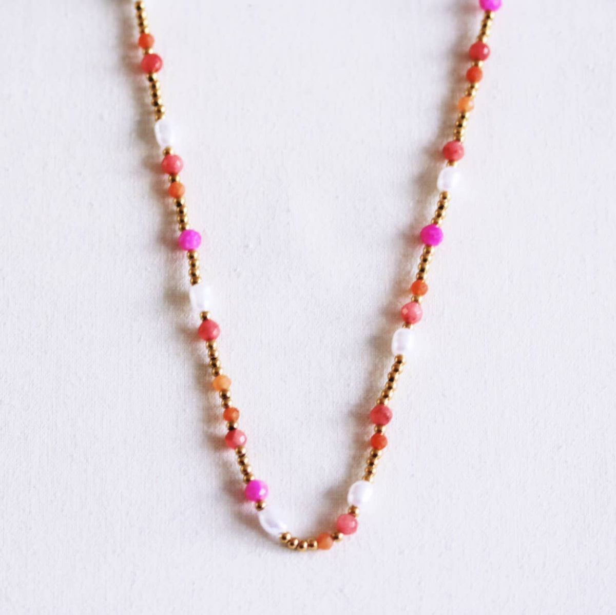 Beaded necklace with pearls and facets - coral/orange/pink
